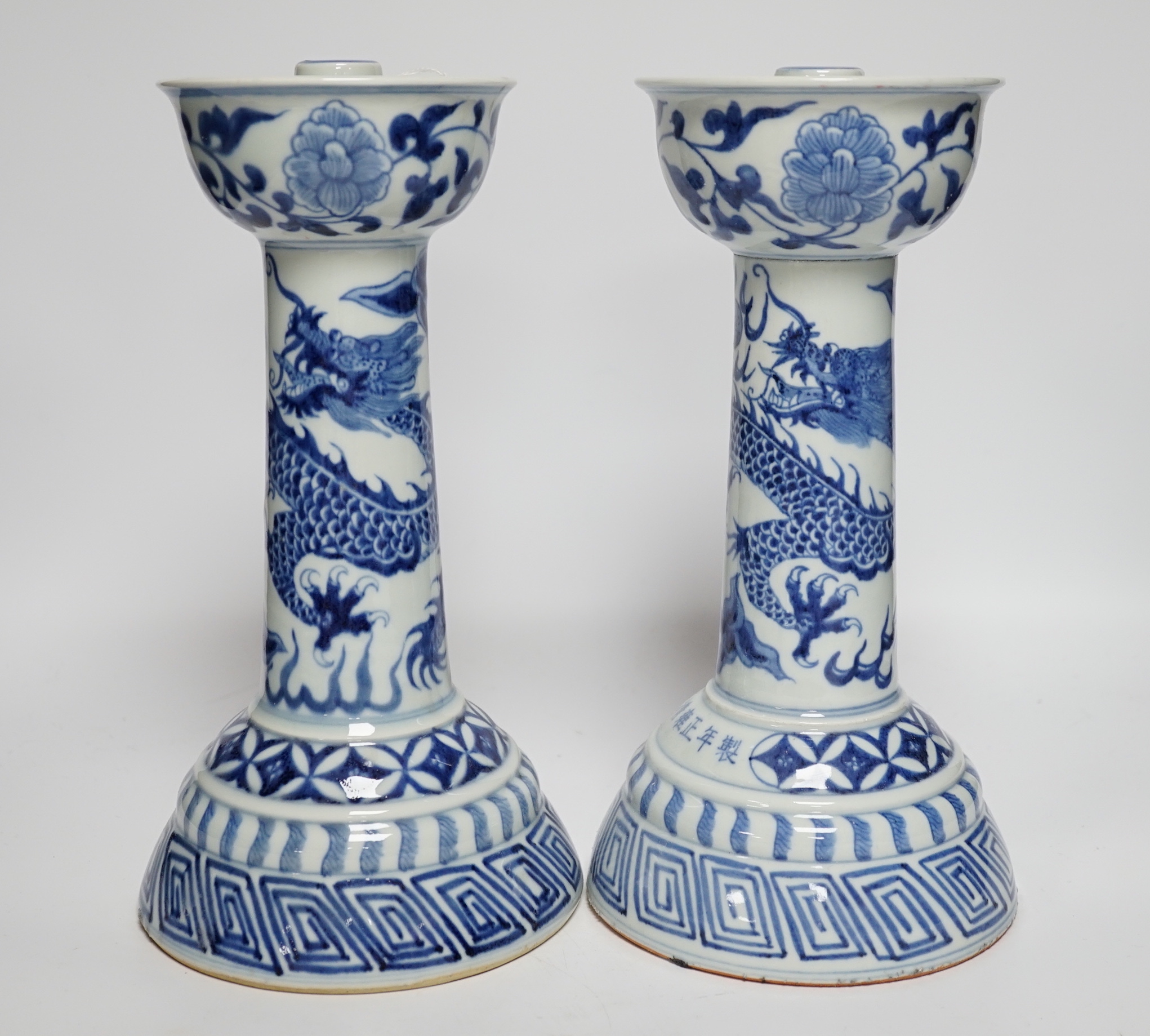 A pair of Chinese blue and white 'dragon' candlesticks, 28.5cm